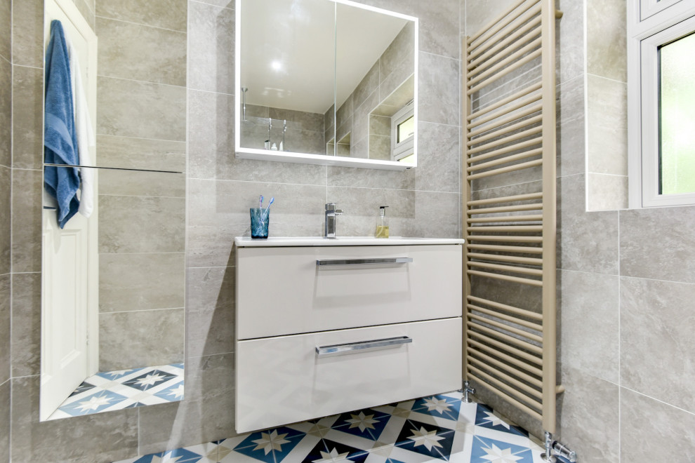 Design ideas for a small contemporary grey and teal ensuite bathroom in Sussex with flat-panel cabinets, beige cabinets, a walk-in shower, a two-piece toilet, beige tiles, ceramic tiles, ceramic flooring, a built-in sink, blue floors, an open shower, feature lighting, a single sink and a floating vanity unit.