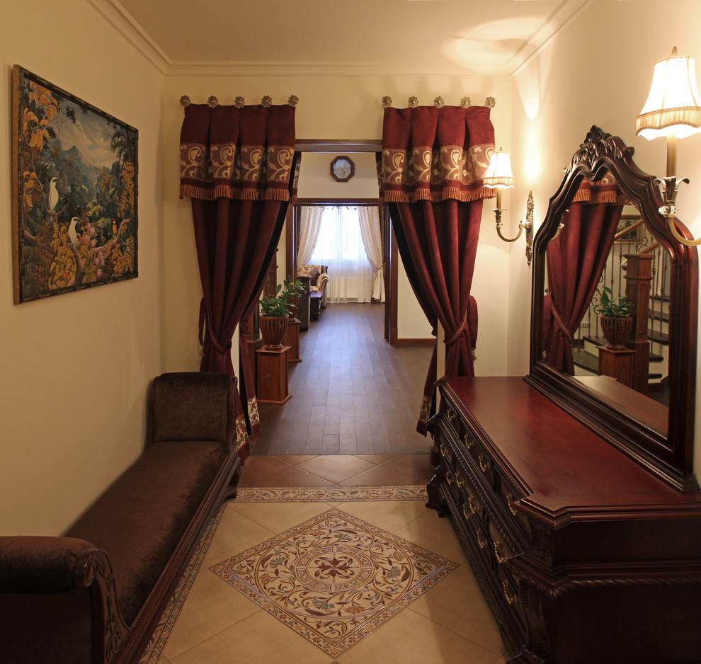 Mid-sized traditional vestibule in Moscow with beige walls, porcelain floors and beige floor.