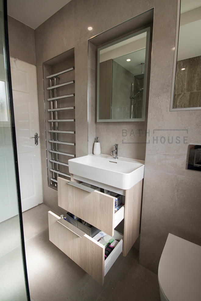Small contemporary ensuite wet room bathroom in Dublin with flat-panel cabinets, brown cabinets, a wall mounted toilet, beige tiles, ceramic tiles, beige walls, ceramic flooring, a wall-mounted sink, beige floors, an open shower, white worktops, a shower bench, a single sink and a floating vanity unit.