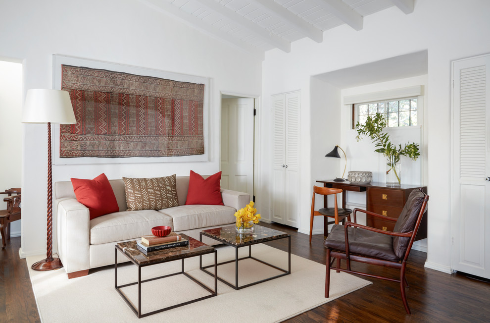 Mediterranean master bedroom in Los Angeles with white walls, medium hardwood floors and brown floor.