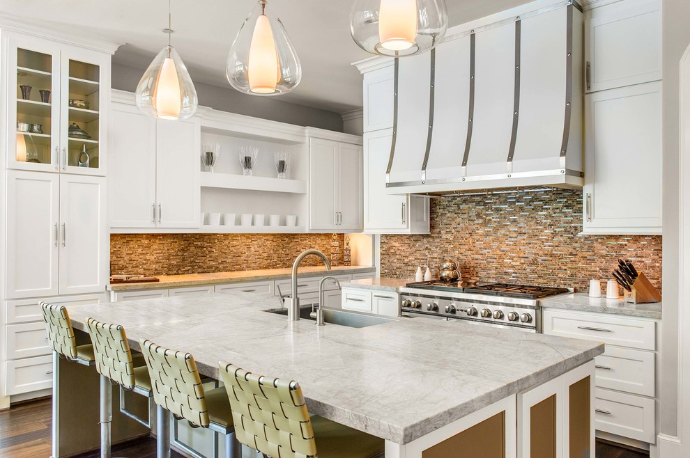 Inspiration for a transitional l-shaped kitchen in Houston with a farmhouse sink, shaker cabinets, white cabinets, metallic splashback, mosaic tile splashback, stainless steel appliances and with island.