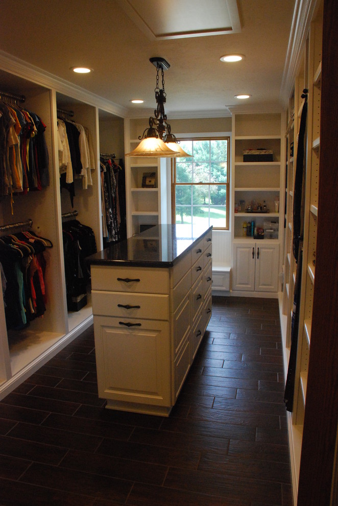 Photo of a large traditional women's dressing room in Cleveland with open cabinets, white cabinets and ceramic floors.