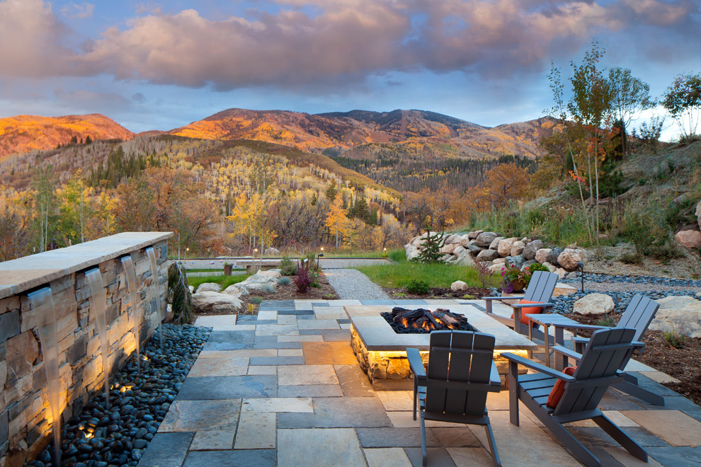 Inspiration for a large transitional backyard tile patio remodel in Denver with a fire pit and no cover