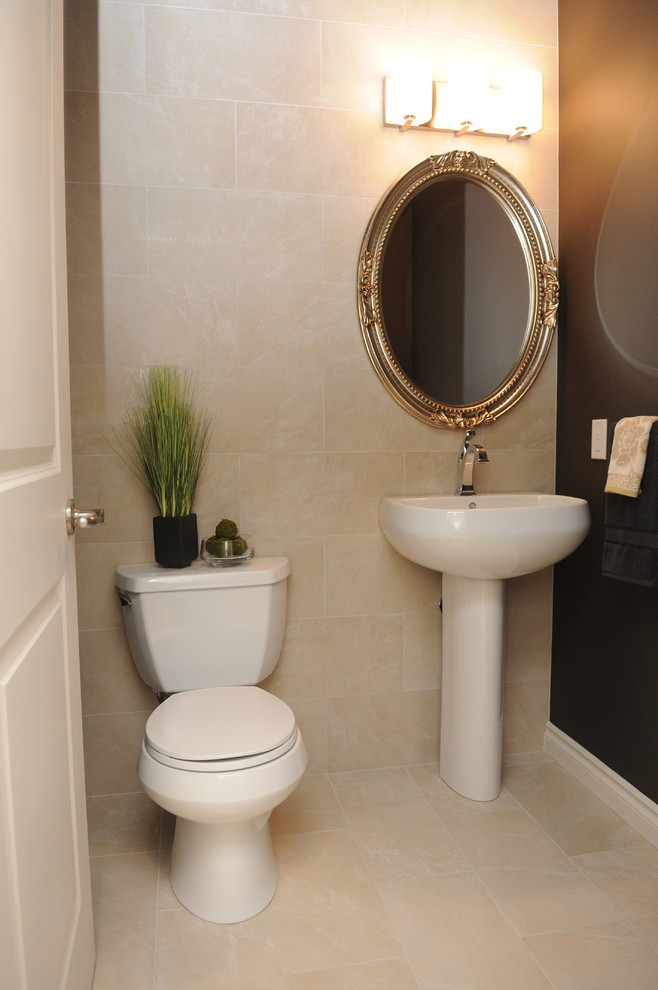 Photo of a small traditional powder room in Other with a two-piece toilet, beige tile, porcelain tile, brown walls, porcelain floors and a pedestal sink.