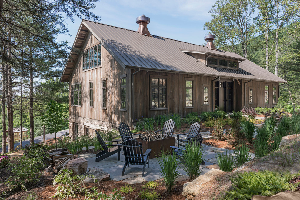 Design ideas for a mid-sized country front yard patio in Other with a fire feature, no cover and natural stone pavers.