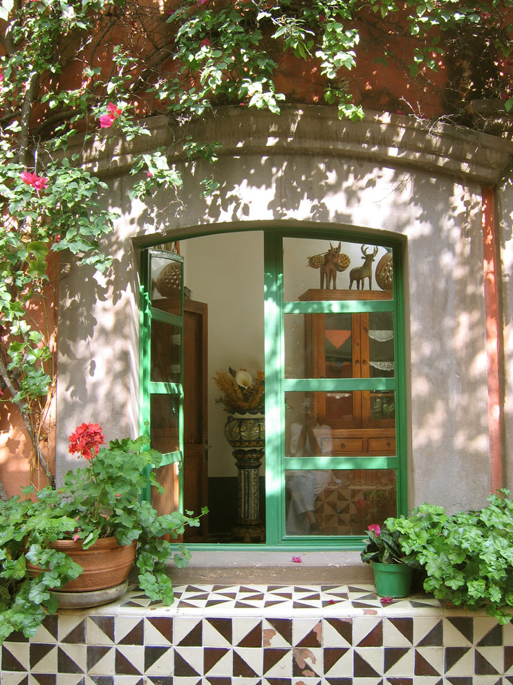 Photo of a mediterranean entry hall in Other with a double front door and a green front door.