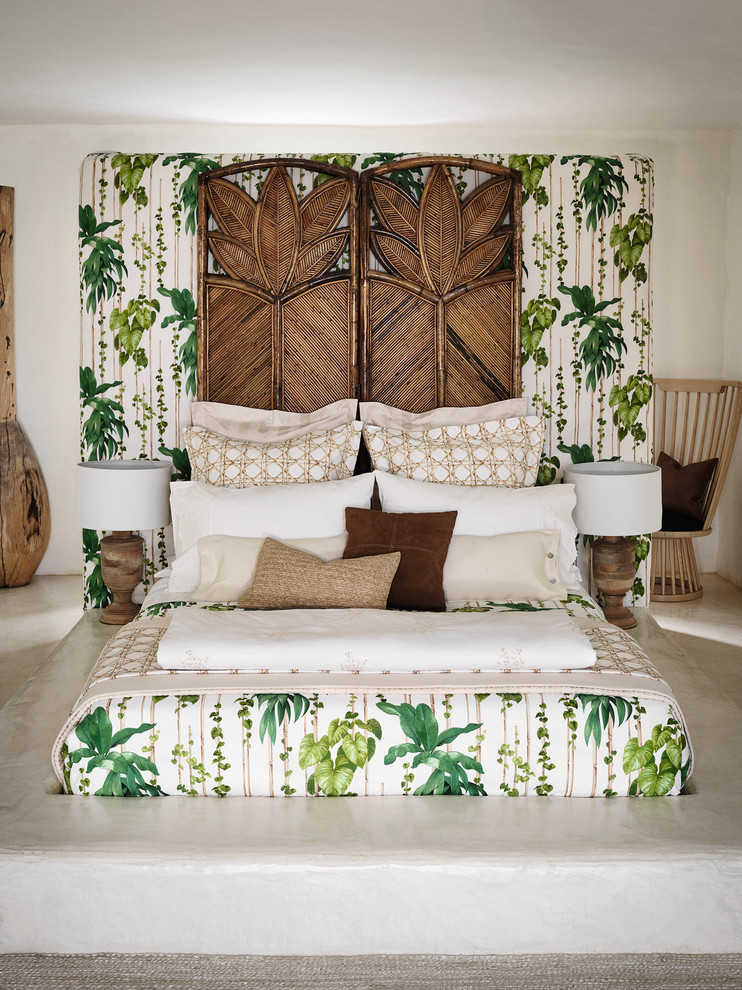 Mid-sized tropical master bedroom in Other with white walls.