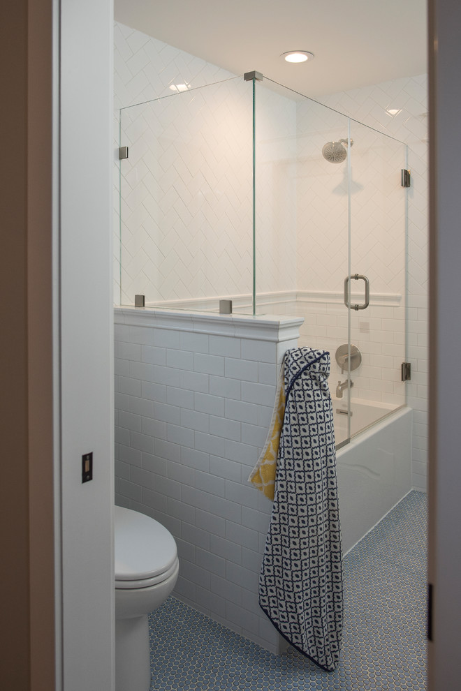 Mid-sized arts and crafts 3/4 bathroom in DC Metro with recessed-panel cabinets, dark wood cabinets, an alcove tub, a shower/bathtub combo, white tile, subway tile, grey walls, an undermount sink, engineered quartz benchtops, blue floor and a hinged shower door.