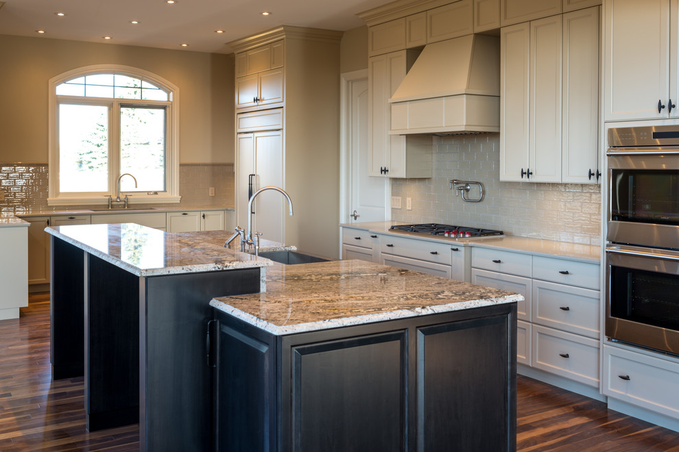 Large transitional medium tone wood floor eat-in kitchen photo in Calgary with recessed-panel cabinets, beige cabinets, beige backsplash, subway tile backsplash and an island