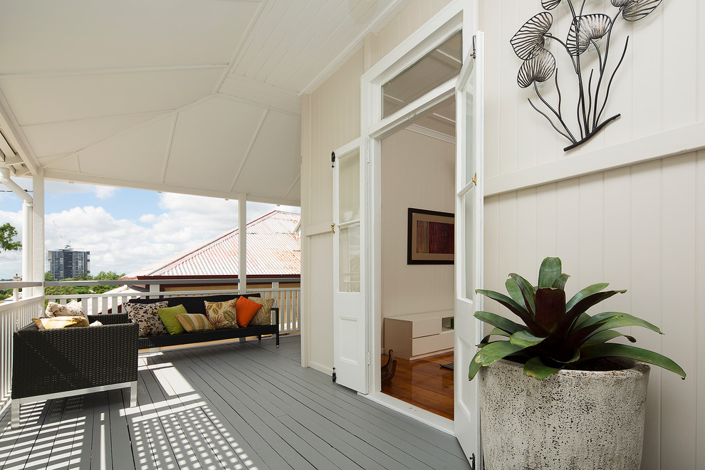 Inspiration for a small transitional front yard verandah in Gold Coast - Tweed with decking and a roof extension.