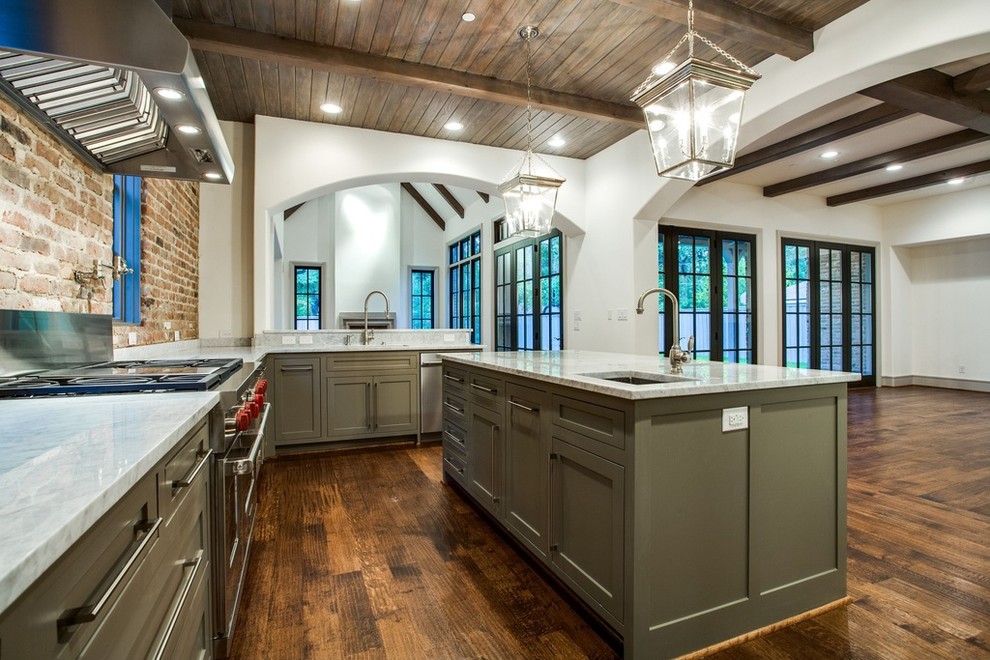 This is an example of a large industrial l-shaped separate kitchen in Dallas with an undermount sink, shaker cabinets, green cabinets, marble benchtops, red splashback, brick splashback, stainless steel appliances, dark hardwood floors, with island, brown floor and grey benchtop.