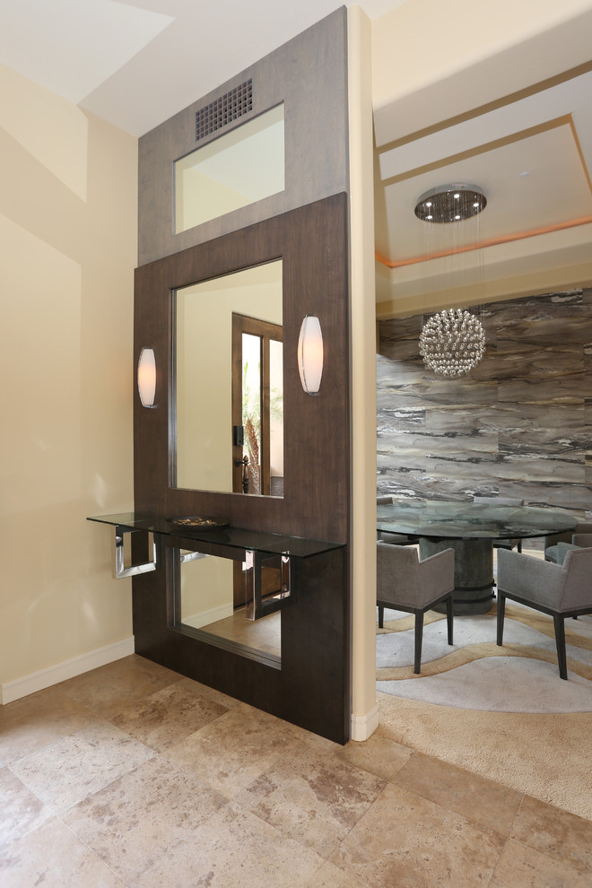 Example of a mid-sized trendy limestone floor entryway design in Phoenix with beige walls and a brown front door