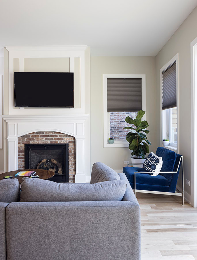 Example of a 1950s open concept family room design in Chicago with a standard fireplace, a brick fireplace and a wall-mounted tv