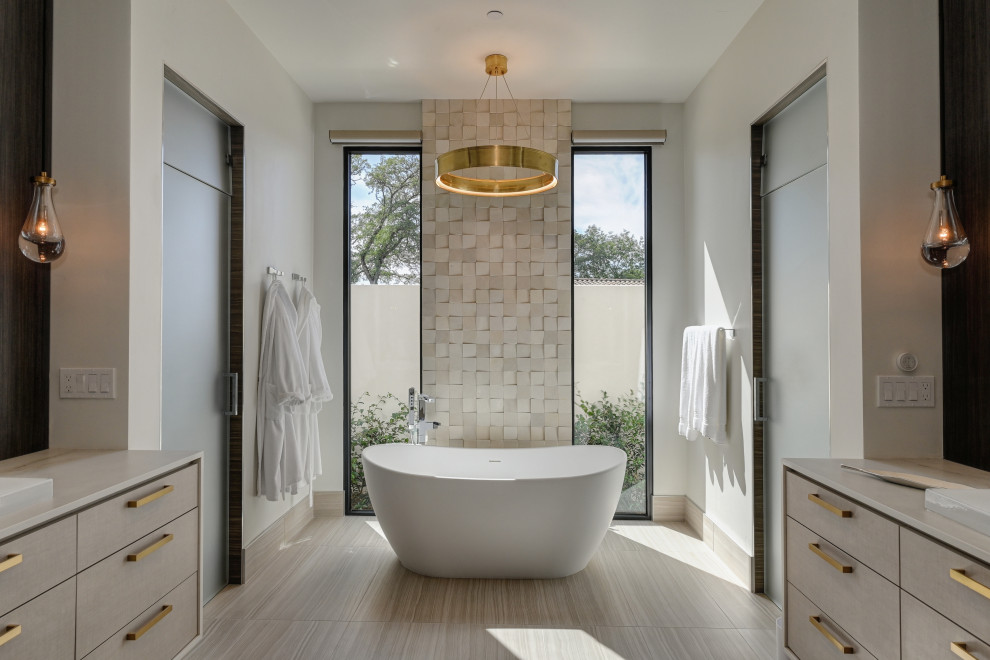 Photo of a contemporary master bathroom in Sacramento with recessed-panel cabinets, light wood cabinets, a freestanding tub, a curbless shower, white tile, porcelain floors, an undermount sink, beige floor, a hinged shower door, a double vanity and a floating vanity.