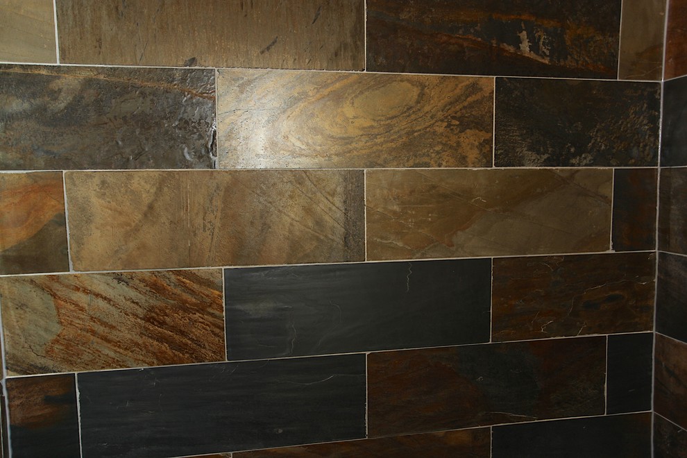 Large mountain style master slate tile brown floor home design photo in Indianapolis with brown cabinets, beige walls and an undermount sink