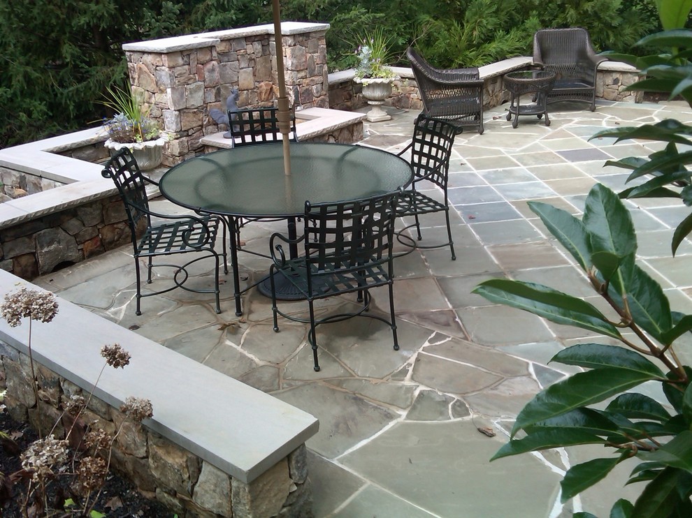 Inspiration for a large contemporary backyard patio in DC Metro with natural stone pavers, a fire feature and no cover.