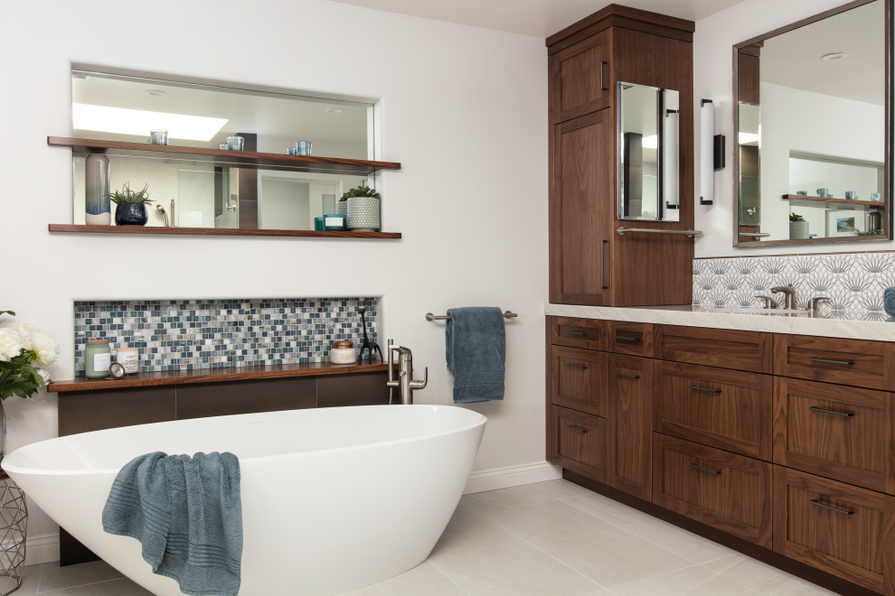This is an example of a medium sized coastal ensuite bathroom in San Diego with shaker cabinets, brown cabinets, a freestanding bath, a double shower, brown tiles, wood-effect tiles, white walls, ceramic flooring, an integrated sink, engineered stone worktops, white floors, a hinged door, beige worktops, double sinks and a built in vanity unit.