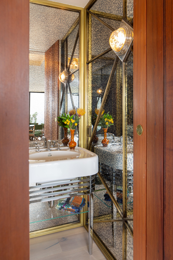 Photo of a small midcentury powder room in San Diego with open cabinets, mirror tile, light hardwood floors, a console sink, brown floor, a freestanding vanity and white benchtops.