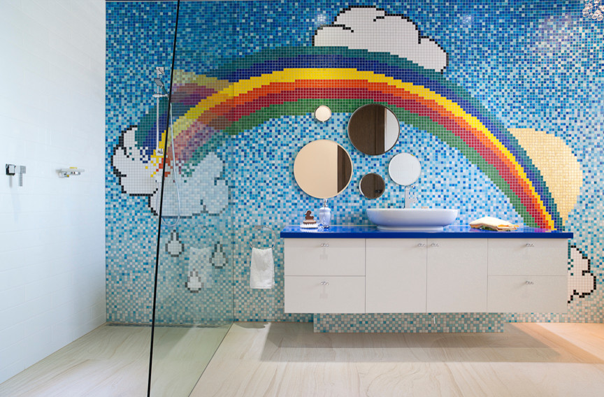 Photo of a large contemporary kids bathroom in Melbourne with flat-panel cabinets, white cabinets, solid surface benchtops and multi-coloured tile.