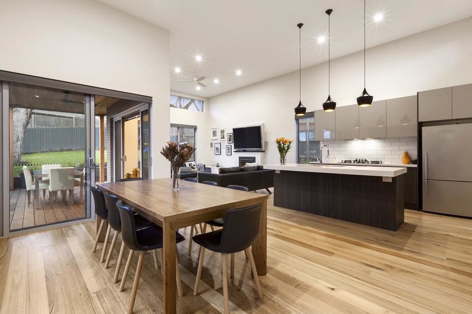 Inspiration for a scandinavian galley eat-in kitchen in Melbourne with an undermount sink, marble benchtops, white splashback, subway tile splashback, stainless steel appliances, light hardwood floors and with island.