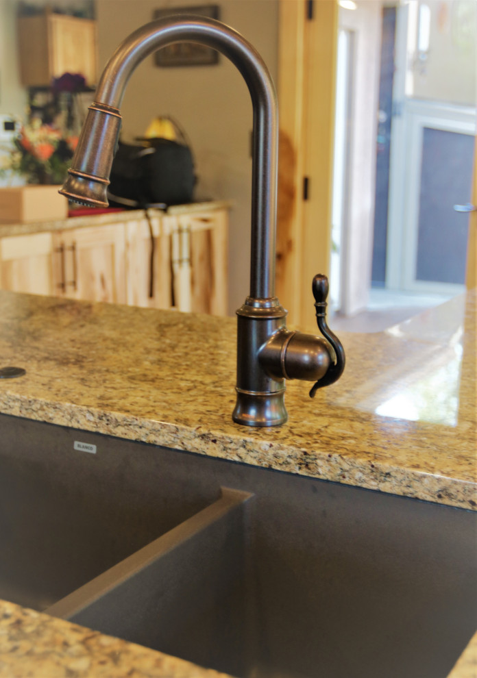 Large mountain style kitchen photo with granite countertops and stone tile backsplash