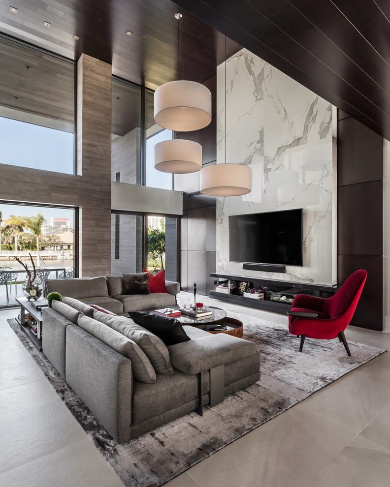 Inspiration for an expansive contemporary open concept living room in Miami with multi-coloured walls, a wall-mounted tv, beige floor and ceramic floors.