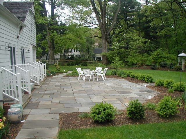 Photo of a small contemporary backyard patio in New York with natural stone pavers and no cover.