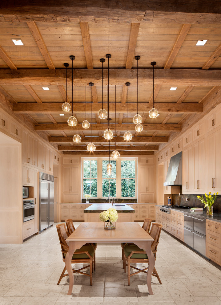 Mid-sized mountain style l-shaped travertine floor and beige floor enclosed kitchen photo in Houston with an integrated sink, shaker cabinets, beige cabinets, quartz countertops, gray backsplash, stone slab backsplash, stainless steel appliances and an island