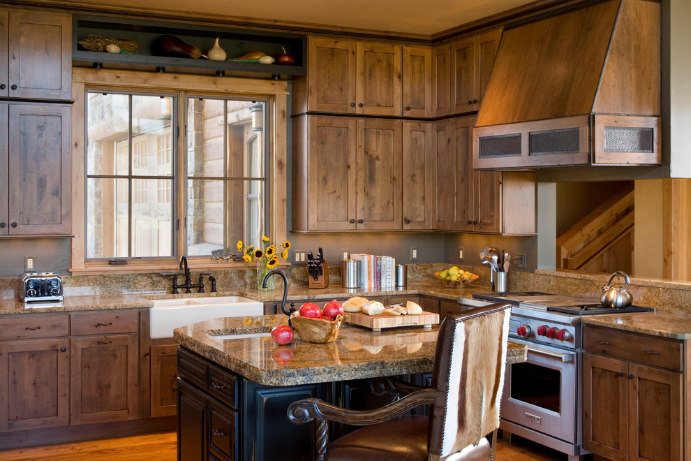 Example of a mid-sized mountain style l-shaped medium tone wood floor kitchen design with a farmhouse sink, recessed-panel cabinets, medium tone wood cabinets and an island