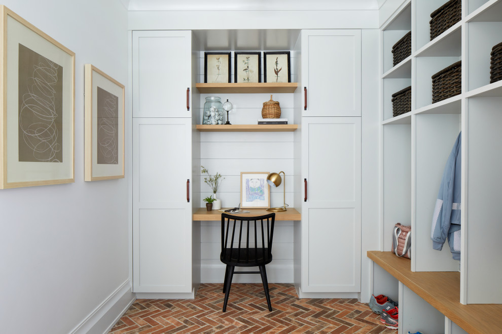 Farmhouse boot room in New York with white walls, brick flooring and multi-coloured floors.
