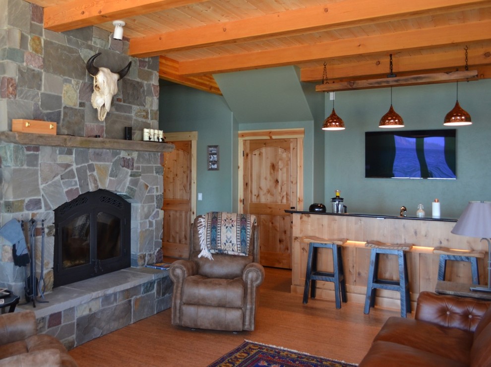 This is an example of a mid-sized country open concept living room in Other with a home bar, green walls, cork floors, a standard fireplace, a stone fireplace surround and brown floor.