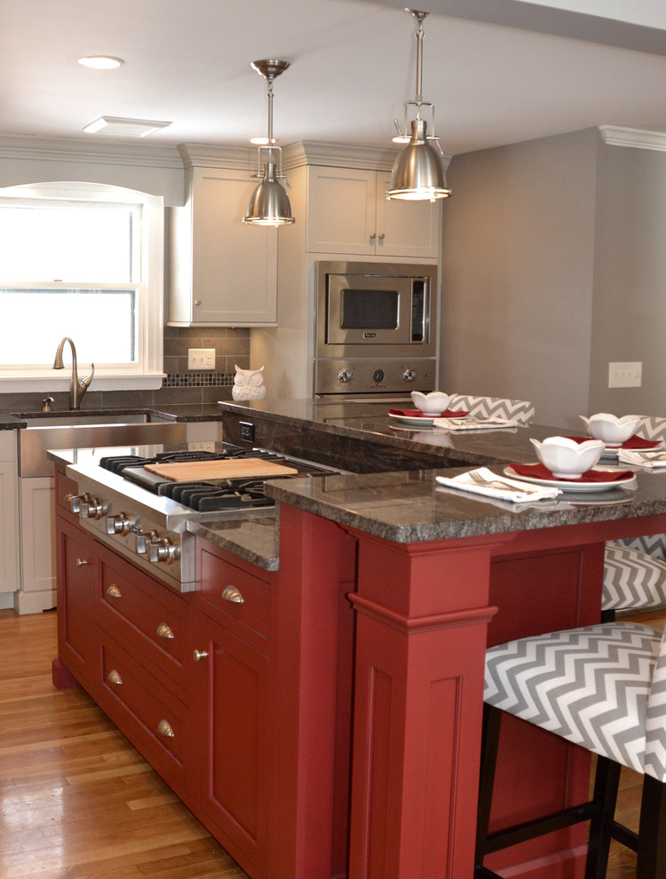 Design ideas for a transitional kitchen in Boston with recessed-panel cabinets, grey cabinets, granite benchtops, grey splashback, stainless steel appliances and light hardwood floors.