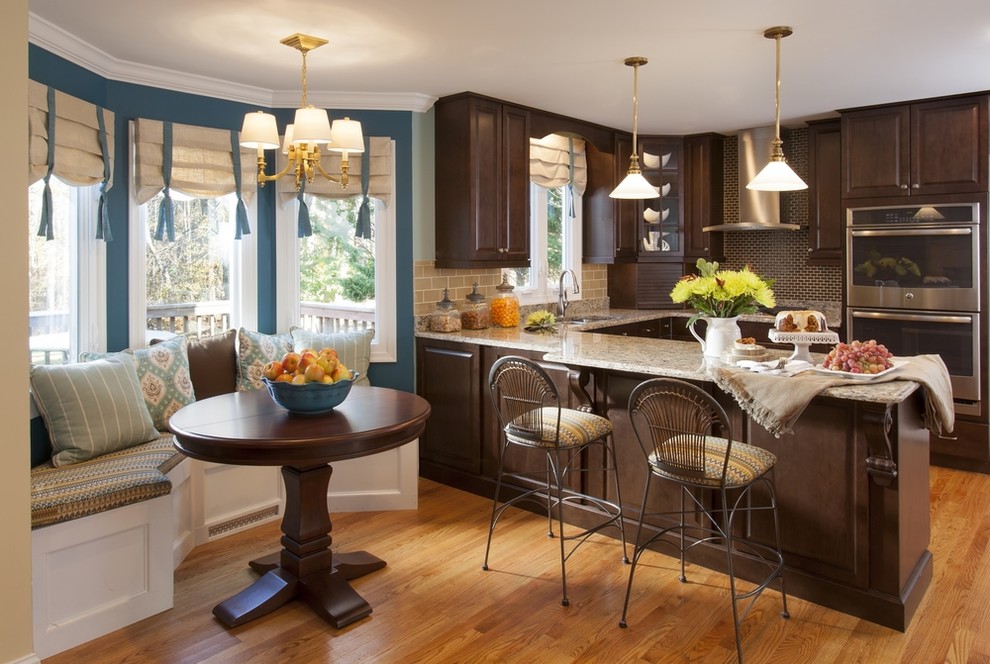 Example of a mid-sized transitional u-shaped medium tone wood floor and brown floor kitchen pantry design in DC Metro with a drop-in sink, raised-panel cabinets, dark wood cabinets, granite countertops, beige backsplash, glass tile backsplash, stainless steel appliances and no island