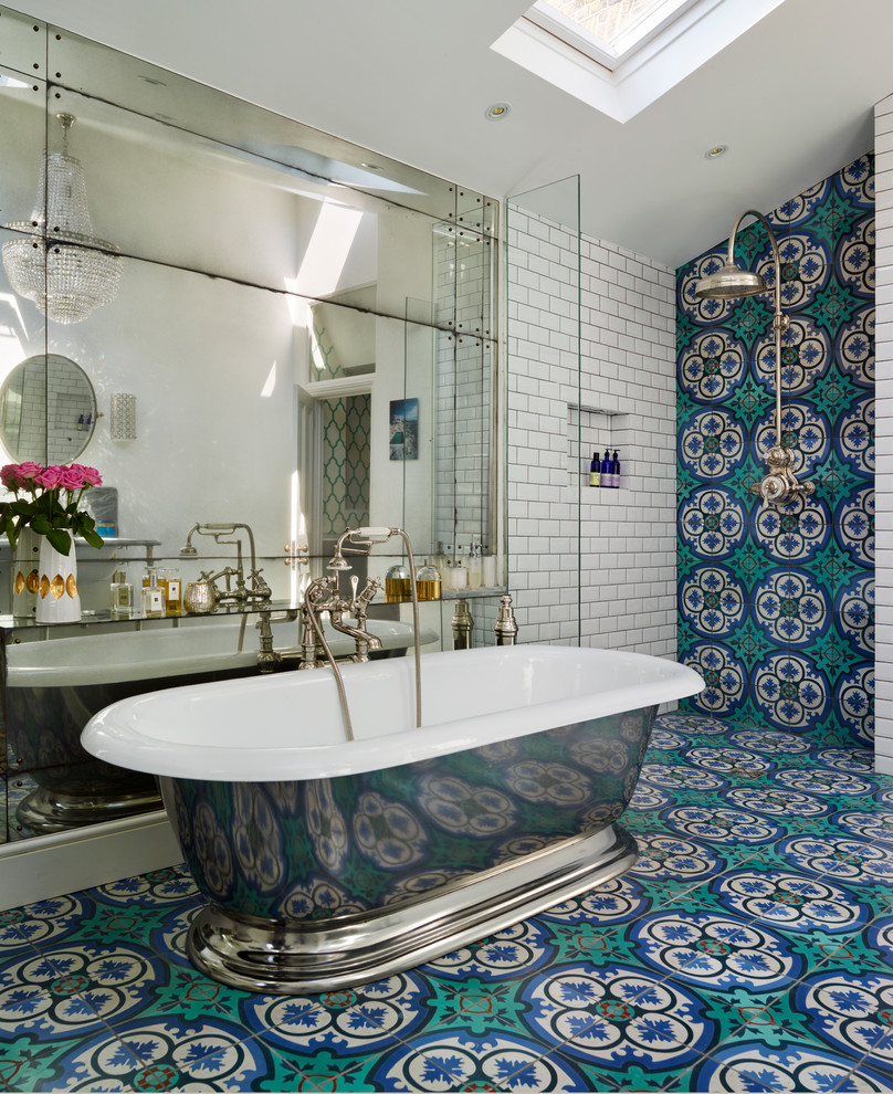 Large eclectic bathroom in London with turquoise floor.