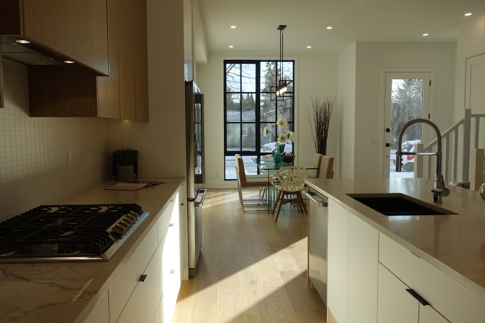 Example of a transitional kitchen design in Calgary