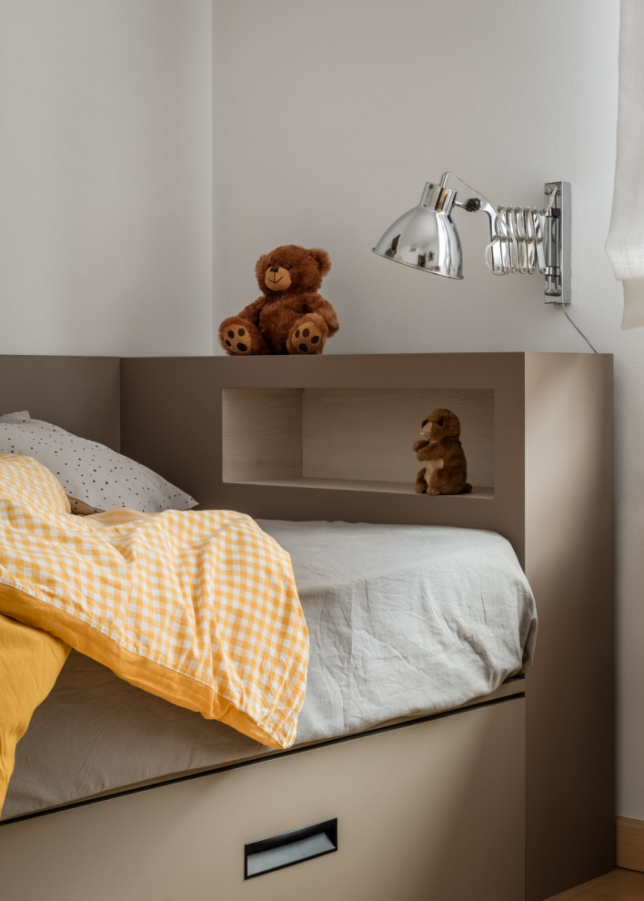 Medium sized traditional gender neutral kids' bedroom in Barcelona with white walls and medium hardwood flooring.
