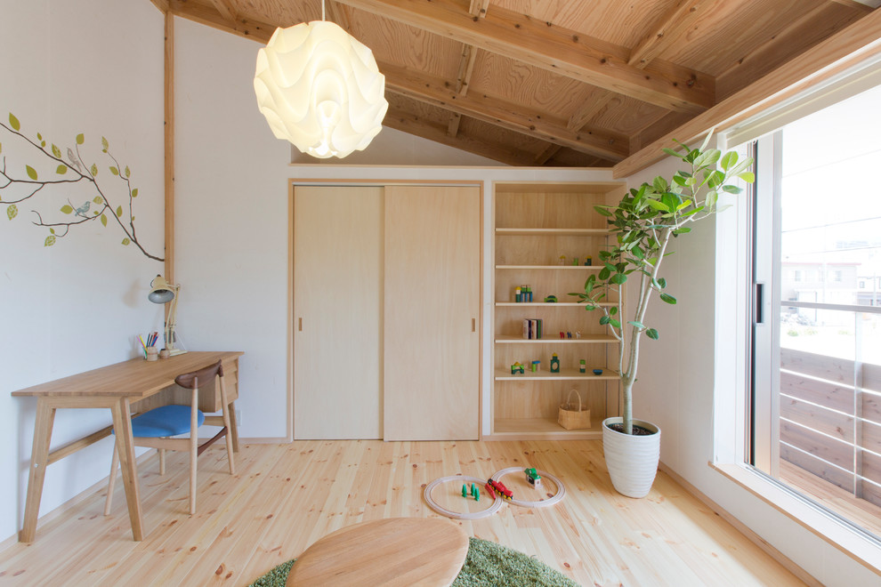 Photo of a scandinavian gender-neutral kids' playroom for kids 4-10 years old in Tokyo Suburbs with white walls, light hardwood floors and beige floor.