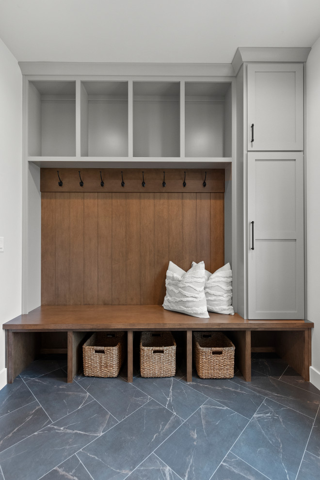 Mid-sized transitional vinyl floor and black floor mudroom photo with white walls