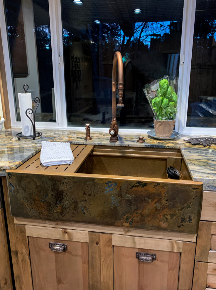 Inspiration for a medium sized rustic l-shaped kitchen/diner in Los Angeles with a belfast sink, shaker cabinets, medium wood cabinets, white splashback, stainless steel appliances, medium hardwood flooring, an island and multicoloured worktops.