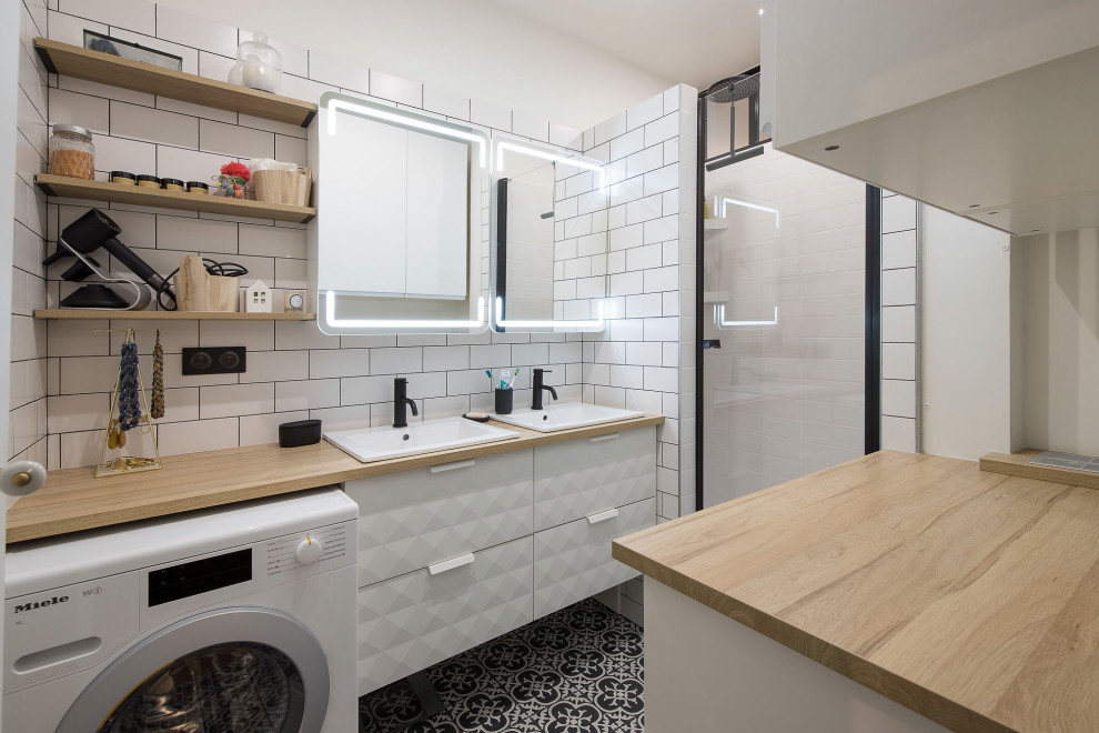 Design ideas for a contemporary 3/4 bathroom in Paris with beaded inset cabinets, white cabinets, an alcove shower, white tile, ceramic tile, white walls, cement tiles, an undermount sink, laminate benchtops, black floor, a hinged shower door, beige benchtops, a laundry, a double vanity and a floating vanity.