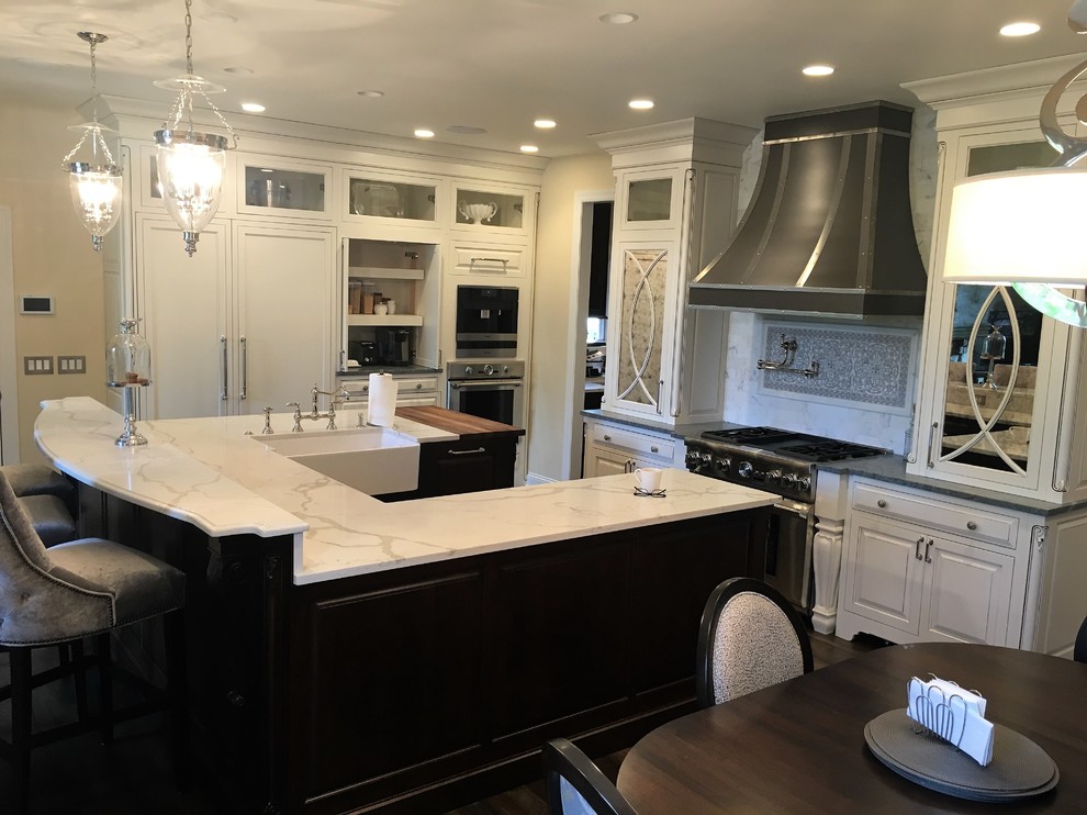 Large transitional dark wood floor kitchen pantry photo in Chicago with a farmhouse sink, beaded inset cabinets, white cabinets, marble countertops, white backsplash, stone tile backsplash, stainless steel appliances and an island