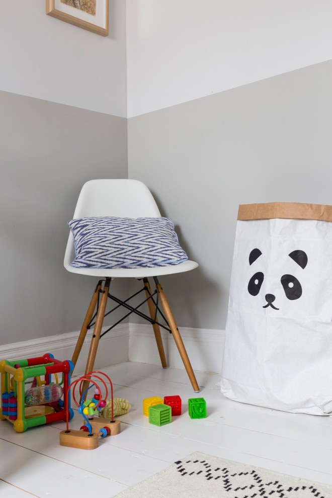Design ideas for a mid-sized transitional kids' room for boys in London with multi-coloured walls and painted wood floors.