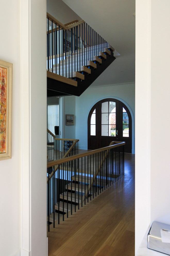 Design ideas for an expansive modern wood floating mixed railing staircase in DC Metro with tongue and groove walls.