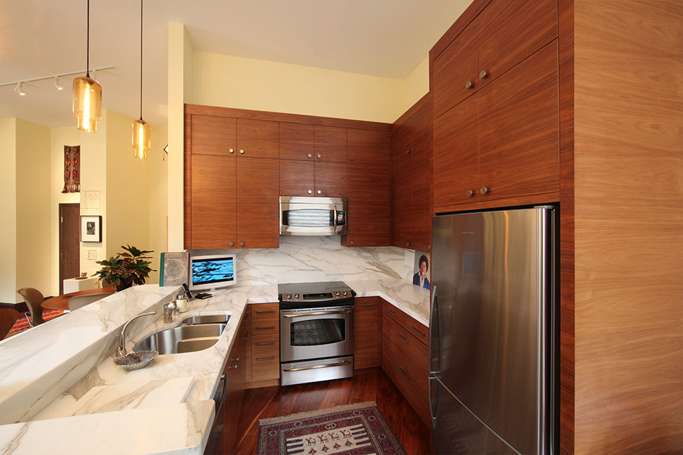 Photo of a small eclectic u-shaped kitchen in San Francisco with flat-panel cabinets, medium wood cabinets, marble benchtops, a double-bowl sink, stone slab splashback, stainless steel appliances and medium hardwood floors.