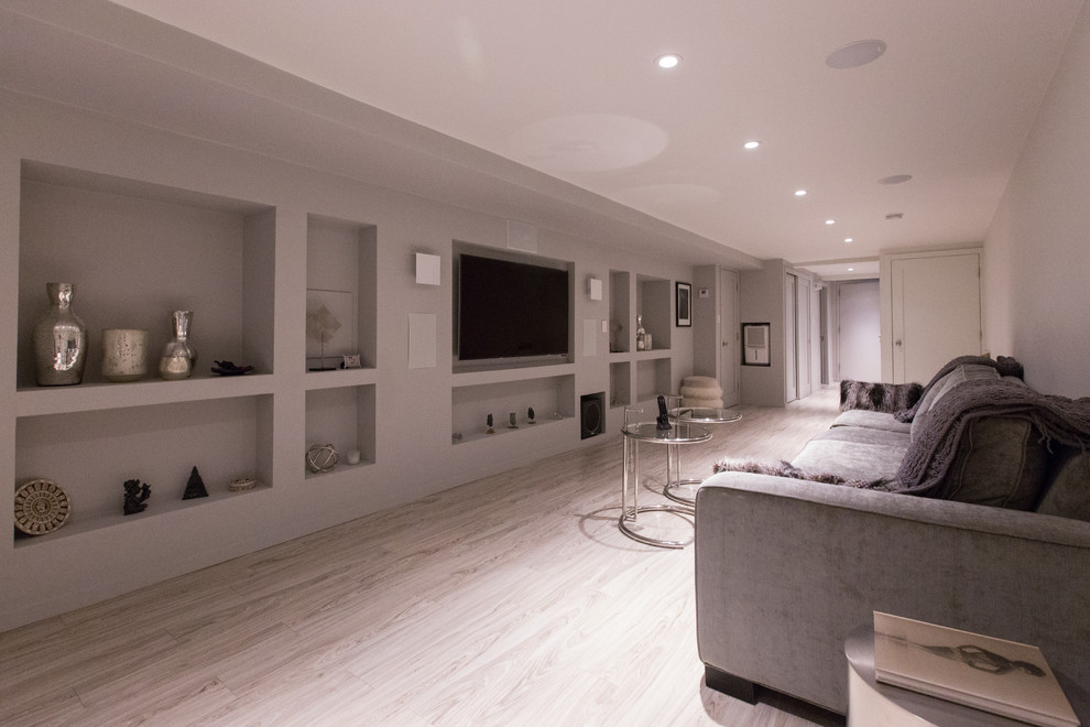 Design ideas for a large modern open concept home theatre in New York with grey walls, bamboo floors and a wall-mounted tv.