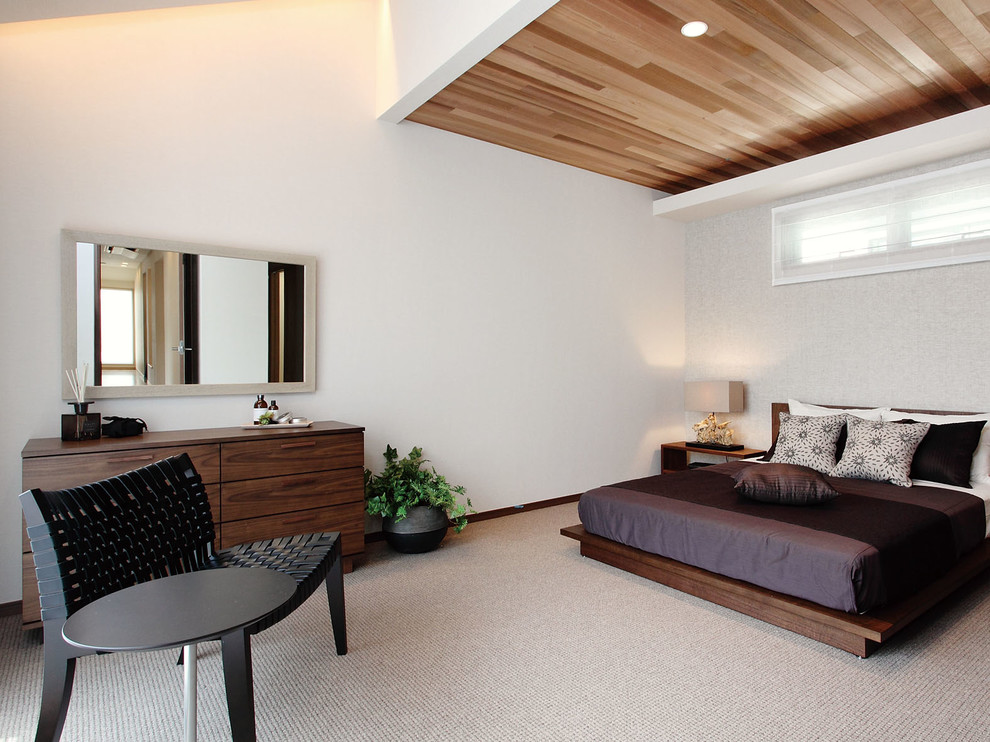 Diseño de dormitorio principal con paredes blancas, moqueta y suelo beige