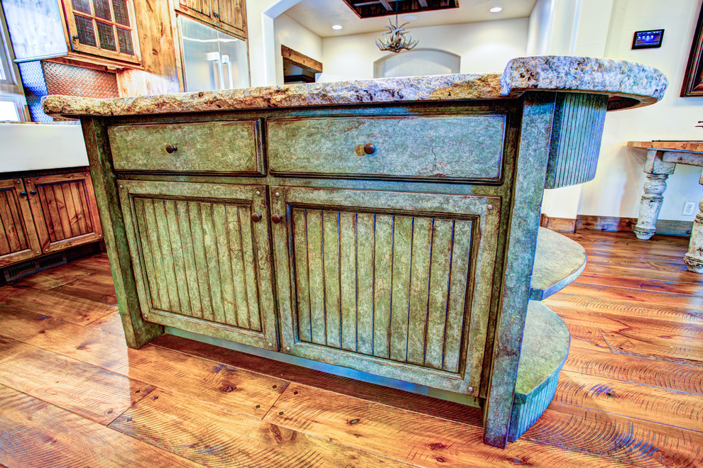 Inspiration for a mid-sized rustic l-shaped dark wood floor open concept kitchen remodel with a farmhouse sink, recessed-panel cabinets, distressed cabinets, granite countertops, metallic backsplash, metal backsplash, stainless steel appliances and an island