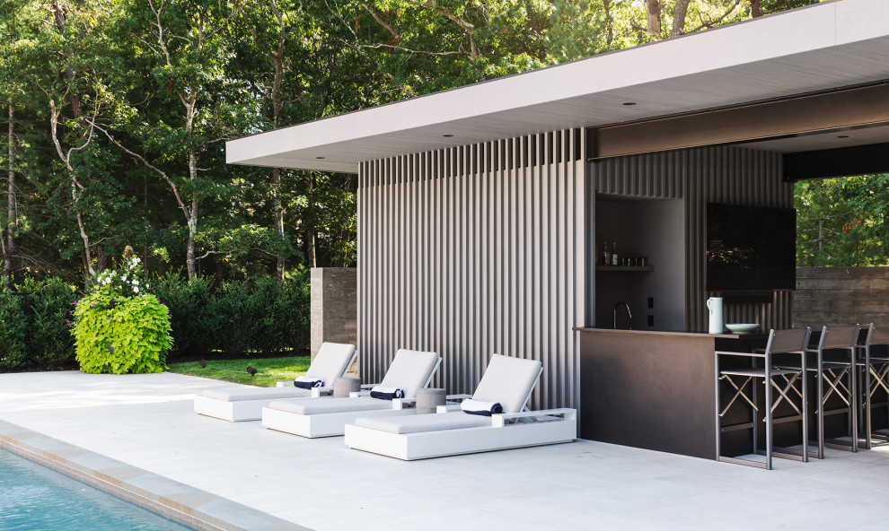 Inspiration pour une petite terrasse latérale design avec une cuisine d'été, des pavés en pierre naturelle et un gazebo ou pavillon.