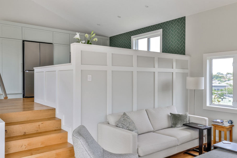 Photo of a Mid-sized contemporary U-shaped eat-in kitchen in Auckland With an Undermount Sink, Shaker Cabinets, Green Cabinets, Quartz Benchtops, Green Splashback, Subway Tile Splashback, Stainless Steel Appliances, Medium Hardwood Floors, a Peninsula, Brown Floor, White Benchtop and Vaulted.