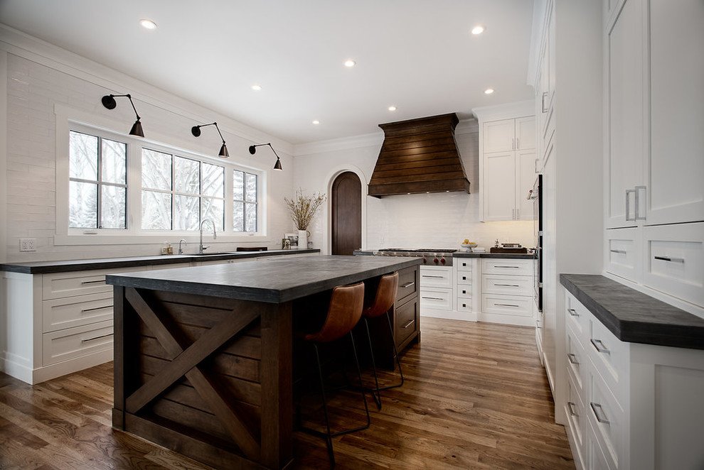 Example of a large transitional u-shaped eat-in kitchen design in Calgary with shaker cabinets, paneled appliances and an island